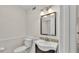 Cozy half-bath featuring a decorative mirror and elegant sink at 5850 Cypress Gardens Blvd # 206, Winter Haven, FL 33884