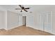 Bedroom features wood-look floors, ceiling fan, and closet space at 5850 Cypress Gardens Blvd # 206, Winter Haven, FL 33884