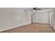 Bright bedroom featuring wood-look floors, ceiling fan, and ample closet space at 5850 Cypress Gardens Blvd # 206, Winter Haven, FL 33884