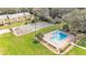 Aerial showcasing community pool and tennis courts, nestled in well-maintained landscaping at 5850 Cypress Gardens Blvd # 206, Winter Haven, FL 33884