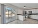 Kitchen with stainless steel appliances and access to the screened patio at 5850 Cypress Gardens Blvd # 206, Winter Haven, FL 33884