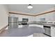 Traditional kitchen featuring white cabinets, stainless steel appliances, and a breakfast bar at 5850 Cypress Gardens Blvd # 206, Winter Haven, FL 33884