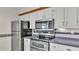 Close-up of the kitchen with stainless steel appliances including a microwave, oven, and refrigerator at 5850 Cypress Gardens Blvd # 206, Winter Haven, FL 33884