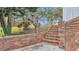 Brick pathway leads to the homes in front of decorative brick wall, and nice landscaping at 5850 Cypress Gardens Blvd # 206, Winter Haven, FL 33884