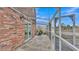 View of a screened patio showcasing the brick exterior and sliding glass door at 5850 Cypress Gardens Blvd # 206, Winter Haven, FL 33884