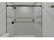Walk in shower featuring white tile and black fixtures at 5850 Cypress Gardens Blvd # 206, Winter Haven, FL 33884