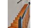 Wooden staircase with black handrail at 5850 Cypress Gardens Blvd # 206, Winter Haven, FL 33884