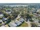 Aerial view of the property, showcasing the surrounding neighborhood with mature trees and a lake view at 6053 Southern Oaks Se Dr, Winter Haven, FL 33884