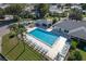 Aerial view of a sparkling pool surrounded by lounge chairs and palm trees, offering a resort-style experience at 6053 Southern Oaks Se Dr, Winter Haven, FL 33884
