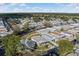 Aerial view of a cozy home featuring a covered parking area and sunroom in a friendly neighborhood at 6053 Southern Oaks Se Dr, Winter Haven, FL 33884
