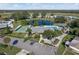 Community clubhouse featuring a pond, fountain, swimming pool, amenity center, and recreational facilities at 6053 Southern Oaks Se Dr, Winter Haven, FL 33884