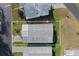 An aerial view of a manufactured home with a gray roof, surrounded by green lawns in a sunny community at 6053 Southern Oaks Se Dr, Winter Haven, FL 33884