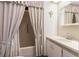 Clean bathroom with a bathtub and shower combination behind a curtain at 6053 Southern Oaks Se Dr, Winter Haven, FL 33884