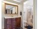 Bathroom features a modern vanity, a large mirror, and a separate shower with a clear glass door at 6053 Southern Oaks Se Dr, Winter Haven, FL 33884