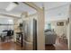 Bright kitchen with white cabinets and stainless steel appliances, adjacent to a dining area and living space at 6053 Southern Oaks Se Dr, Winter Haven, FL 33884