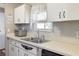 A well-lit kitchen featuring white cabinetry, stainless steel appliances, and a tiled backsplash at 6053 Southern Oaks Se Dr, Winter Haven, FL 33884