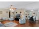Inviting living room featuring a ceiling fan, comfortable seating, and bright natural light at 6053 Southern Oaks Se Dr, Winter Haven, FL 33884