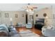 Comfortable living room featuring wood floors, bright paint, and access to dining and kitchen areas at 6053 Southern Oaks Se Dr, Winter Haven, FL 33884