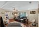 Inviting living room featuring a cozy sofa, wood-look flooring, and ample natural light at 6053 Southern Oaks Se Dr, Winter Haven, FL 33884