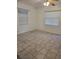 Spacious bedroom featuring tile flooring and bright, natural light from two windows at 639 2Nd St, Polk City, FL 33868