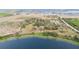 Scenic aerial view of a property nestled near a serene lake and farm land at 660 Duggers Way, Lake Wales, FL 33859