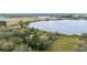 Scenic aerial view of a property nestled near a serene lake and farm land at 660 Duggers Way, Lake Wales, FL 33859
