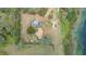 Top-down aerial view of a private property with a brown roof, surrounded by greenery and a pond at 660 Duggers Way, Lake Wales, FL 33859