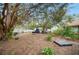 Shaded backyard featuring mature trees, and utility structure; great for outdoor hobbies and relaxation at 660 Duggers Way, Lake Wales, FL 33859