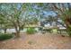 Landscaped backyard of home with lake access and picnic and fire pit areas at 660 Duggers Way, Lake Wales, FL 33859