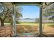 Picturesque view of the lake and backyard from the covered back porch at 660 Duggers Way, Lake Wales, FL 33859