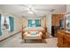 A main bedroom features a four poster bed with colorful bedding and an en suite bathroom at 660 Duggers Way, Lake Wales, FL 33859