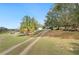 Wide driveway leading to a country home and an outbuilding at 660 Duggers Way, Lake Wales, FL 33859