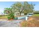 Sloping driveway, mature landscaping and an American flag enhance this home's curb appeal at 660 Duggers Way, Lake Wales, FL 33859