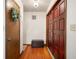 Entryway with rich wood floors, decorative front door, and hallway closet at 660 Duggers Way, Lake Wales, FL 33859