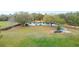 Charming one-story home with a well-maintained lawn, mature trees, and an American flag at 660 Duggers Way, Lake Wales, FL 33859