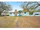 Inviting front exterior featuring a stone chimney and covered porch with chairs at 660 Duggers Way, Lake Wales, FL 33859