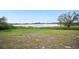 Beautiful lake view with natural grass along the shore, creating a serene and inviting atmosphere at 660 Duggers Way, Lake Wales, FL 33859