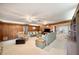 Spacious living room featuring wood paneled walls and carpet flooring at 660 Duggers Way, Lake Wales, FL 33859
