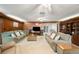 Comfortable living room with wood paneling, plush seating, and built-in shelving at 660 Duggers Way, Lake Wales, FL 33859