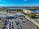 Aerial view of the building and surrounding area, including the lake at 700 Mirror Nw Ter # 111, Winter Haven, FL 33881
