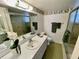 Bathroom view with a sink, mirror, toilet, and enclosed shower at 700 Mirror Nw Ter # 111, Winter Haven, FL 33881