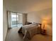 Bright bedroom featuring sliding glass doors with view to enclosed porch at 700 Mirror Nw Ter # 111, Winter Haven, FL 33881