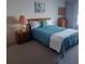 Cozy bedroom features a comfortable bed, soft carpet, and serene decor at 700 Mirror Nw Ter # 111, Winter Haven, FL 33881