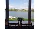 Dining room with a large window overlooking a tranquil lake view at 700 Mirror Nw Ter # 111, Winter Haven, FL 33881