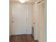 View of entryway with door and closet with new wood-style flooring at 700 Mirror Nw Ter # 111, Winter Haven, FL 33881