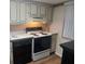 Well-maintained kitchen with black appliances and plenty of cabinet storage at 700 Mirror Nw Ter # 111, Winter Haven, FL 33881