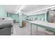 Clean and well-maintained laundry room with multiple washing machines and folding tables at 700 Mirror Nw Ter # 111, Winter Haven, FL 33881