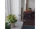 Corner living space featuring sliding doors to another room, neutral tile, plants and a table with chairs at 700 Mirror Nw Ter # 111, Winter Haven, FL 33881