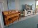 Community lounge featuring an upright piano, a flatscreen television, and comfortable wicker chairs at 700 Mirror Nw Ter # 111, Winter Haven, FL 33881