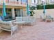 Brick paved patio with seating area and umbrellas in front of the building at 700 Mirror Nw Ter # 111, Winter Haven, FL 33881